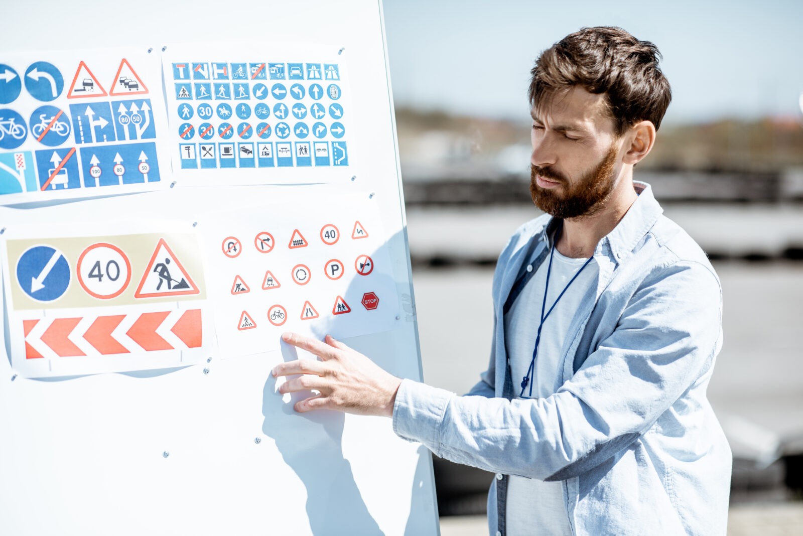 Driver instructor showing traffiic signs