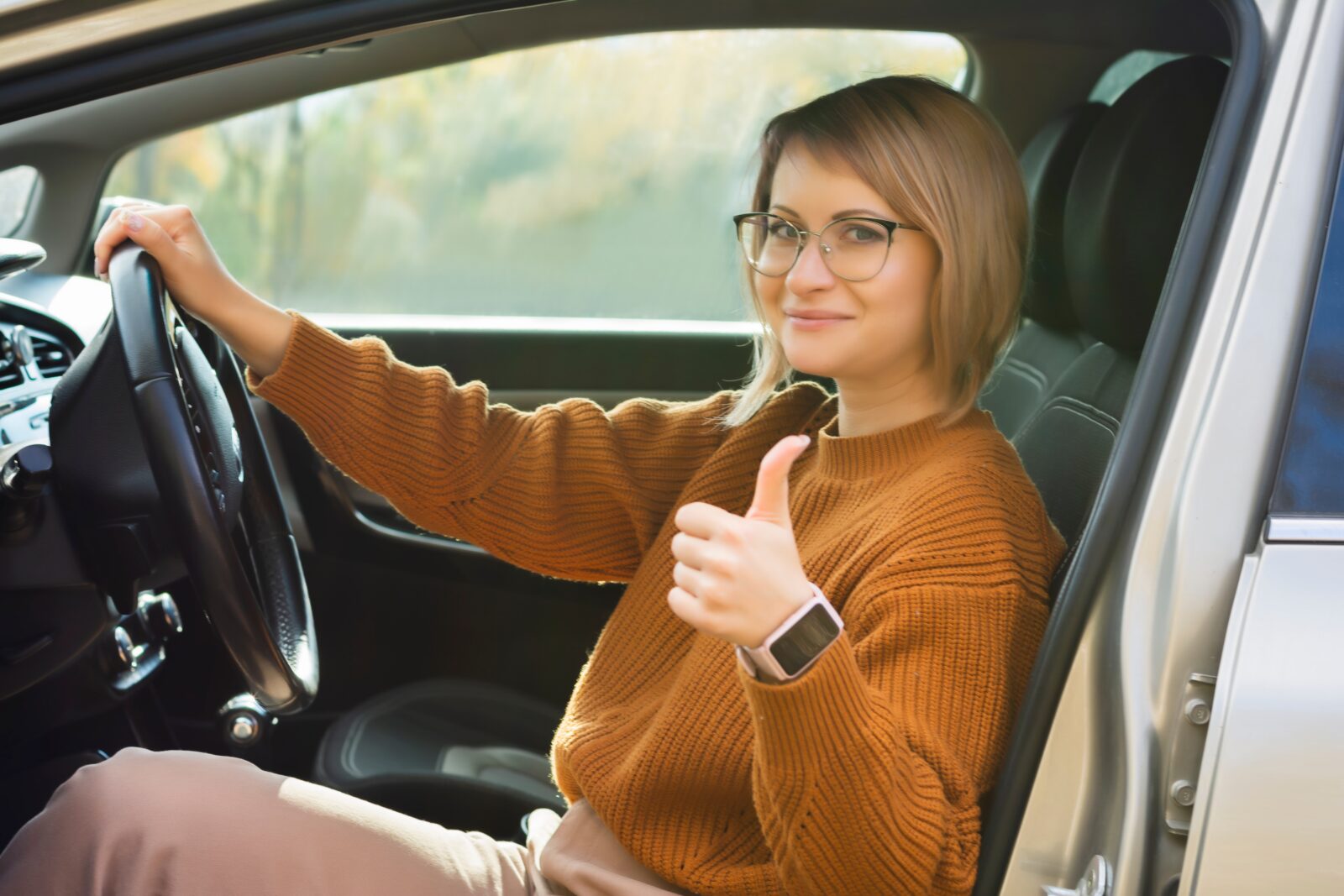 Driving school woman successfully passed exam in driving school looking sitting in car